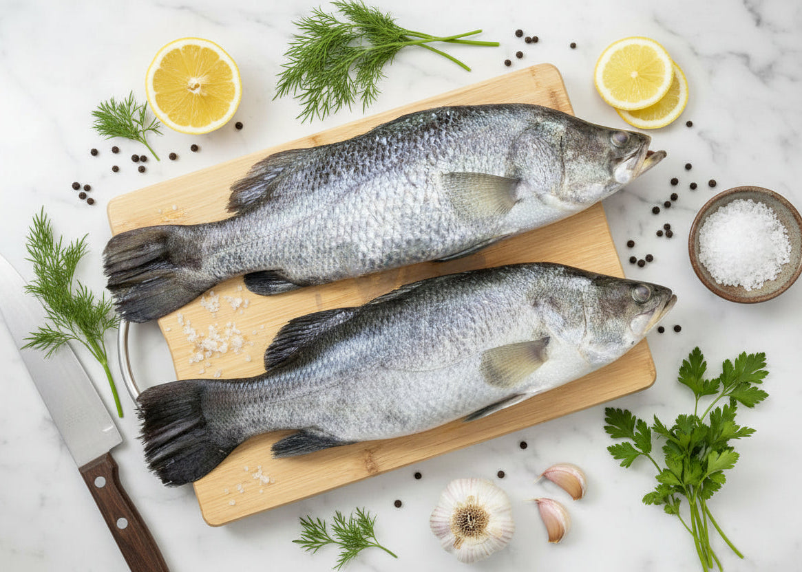 “Fresh Asian Seabass whole fish placed neatly on a clean board, showcasing natural silver‑white skin texture, intact freshness, and VTF’s premium hygienic preparation.”