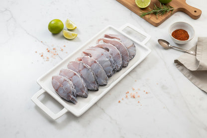 “Fresh Asian Seabass steaks arranged neatly on a clean plate, showcasing natural silver‑white skin, firm texture, and VTF’s premium hygienic preparation.”