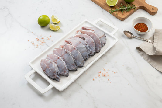 “Fresh Asian Seabass steaks arranged neatly on a clean plate, showcasing natural silver‑white skin, firm texture, and VTF’s premium hygienic preparation.”