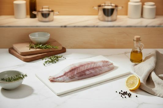 “Asian Seabass boneless fillet placed neatly on a clean plate, showcasing natural white‑pink texture, fresh cut quality, and VTF’s premium hygienic preparation.”