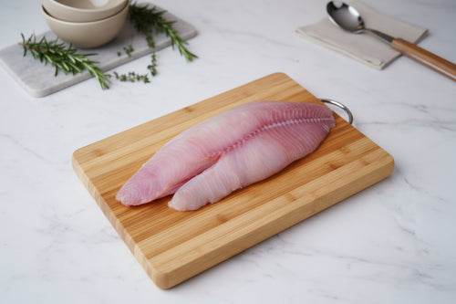 “Murrel (Viral) whole fillet placed neatly on a clean board, showcasing natural pinkish‑white flesh, smooth skin texture, and VTF’s premium hygienic preparation.”